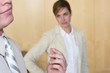 Photo en ligne au meilleur prix businessman rubs fingers while woman looks at him