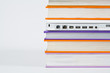 Colorful books with laptop isolated on a white background