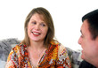 Middle aged adults chatting on a sofa 