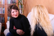 Young females talking on the couch (domestic scenery)