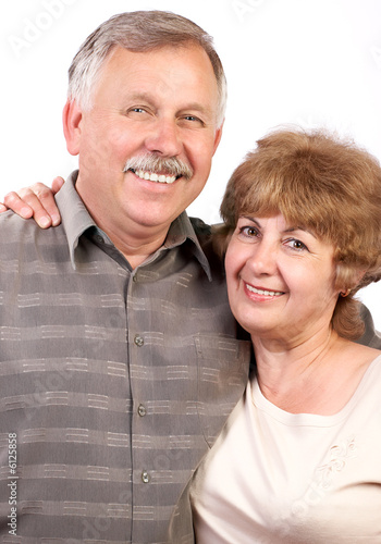 Photo: happy elderly couple in love. over white background. happy elderly couple in love. over white background.