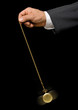 Man's hand holding a pocket watch