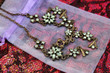 Green gemstone necklace on a small organza bag
