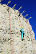 Woman climing a rock wall