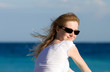 Turned back girl portrait. Seascape background.