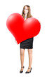 Young woman holding big heart shape in hands. Isolated on white.