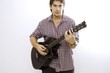 Young male playing acoustic guitar - isolated