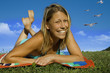 beautiful woman with bikini lying on a meadow.