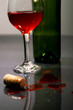 Photo: Spilled Red wine and cork with bottle and a glass Spilled Red wine and cork with bottle and a glass