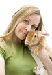 Woman holding little orange rabbit