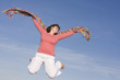 woman jumping in the sky, happy because spring is coming