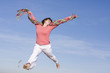 Happy woman jumping in the sky, happy because spring is coming