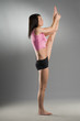 a cute gymnast standing in perfect pose with one leg up