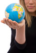 businesswoman holding a mini globe for communications businesswoman holding a mini globe for communications