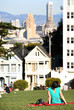 People relaxing on oa sunny day in Alamo park in San Francisco