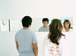 Couple looking in mirror