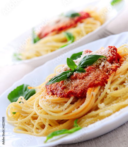 Photo: Pasta with tomato sauce basil and grated parmesan Pasta with tomato sauce basil and grated parmesan