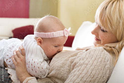 Photo: Mother breast feeding her baby girl Mother breast feeding her baby girl