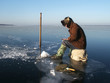 Fisherman catch of fish in the river in the winte sunny day