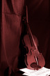 Old violin instrument and music sheet on dark at sepia color