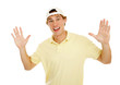 Young college age man throws up his hands in surprise. 