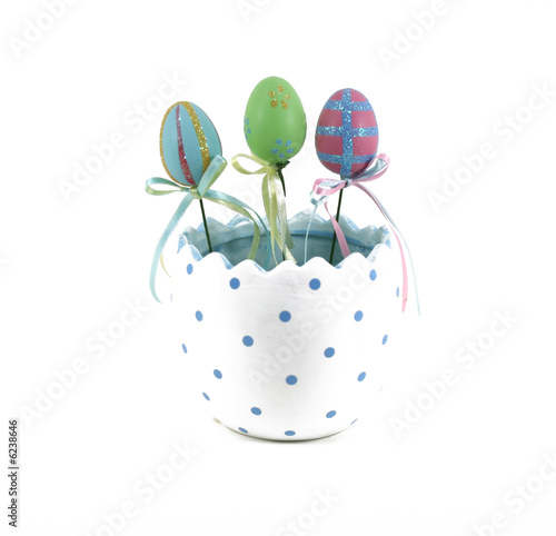Photo: Three decorated Easter eggs in a half egg pot. Three decorated Easter eggs in a half egg pot.