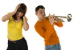 The man trumpet something loud and the woman covering ears