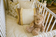Foto: Baby bedroom with crib, pillows and a teddy bear. Baby bedroom with crib, pillows and a teddy bear.