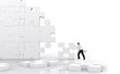business man making a puzzle isolated