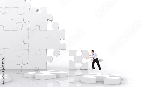 business man making a puzzle isolated 