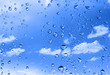 water drops against bright summer sky with cumulus clouds water drops against bright summer sky with cumulus clouds