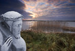 Stone statue of Jesus bearing the cross