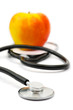 Medical stethoscope and apple, isolated on white background