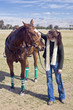Woman speaks to polo horse