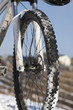 Bike in winter mountains over blue sky
