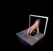 Credit card being stolen by a hand through the 'internet'. 