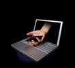 Credit card being stolen by a hand through the 'internet'.  