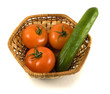 An isolated crib (basket) with tomatoes and cucumber An isolated crib (basket) with tomatoes and cucumber