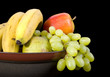 A still life shot of various fruits in a bowl A still life shot of various fruits in a bowl