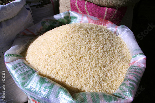 Photo: white rice in sack at market white rice in sack at market