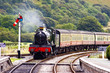 A steam train approaching the station 