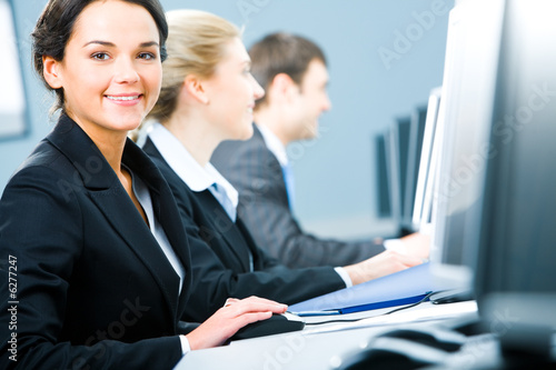 Portrait of pretty specialist sitting at the table 
