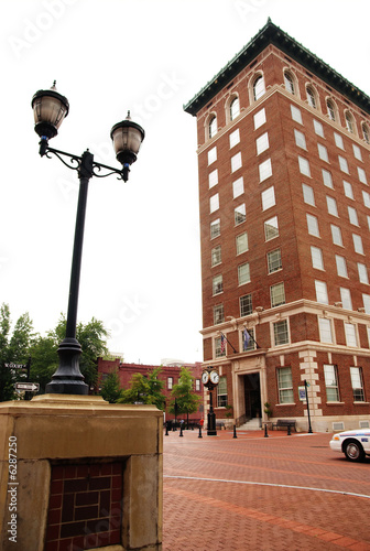 Photo: A tall building on a street side with lamp post. A tall building on a street side with lamp post.