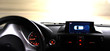 Dashboard part of the car with GPS and driving wheel on the road