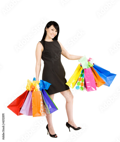Photo: An isolated shot of a beautiful woman carrying shopping bags An isolated shot of a beautiful woman carrying shopping bags