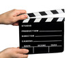 hands holding a movie clapper