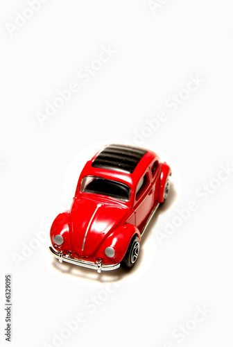 Photo: Red sedan matchbox toy car on white background. Red sedan matchbox toy car on white background.