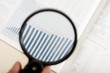 a magnifying glass, financial magazine1