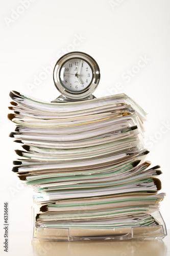 clock on a pile of files