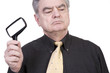 Mature Man with Magnifying Glass